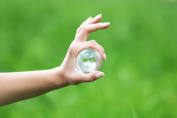 Glass globe in hand — Stock Photo, Image