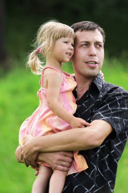 A young father with his daughter on the nature clipart