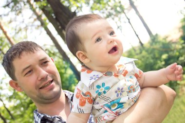 Young father with a charming baby clipart