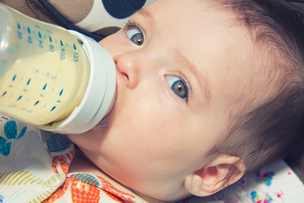 Adorable Seven month Baby eating from bottle