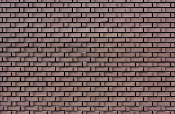 Каменная стена с L-образным кирпичом — стоковое фото