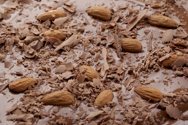 Almond on chocolate syrup — Stok fotoğraf