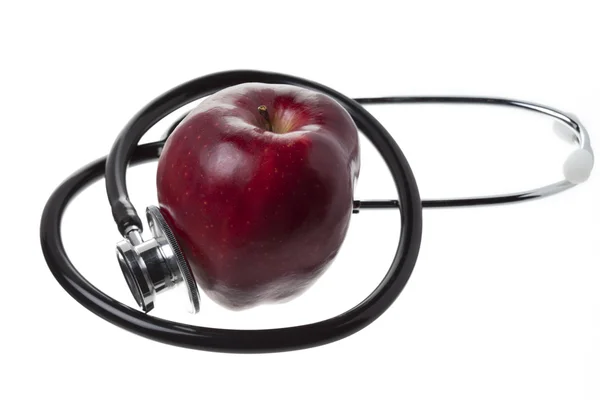 stock image Apple and stethoscope on white background