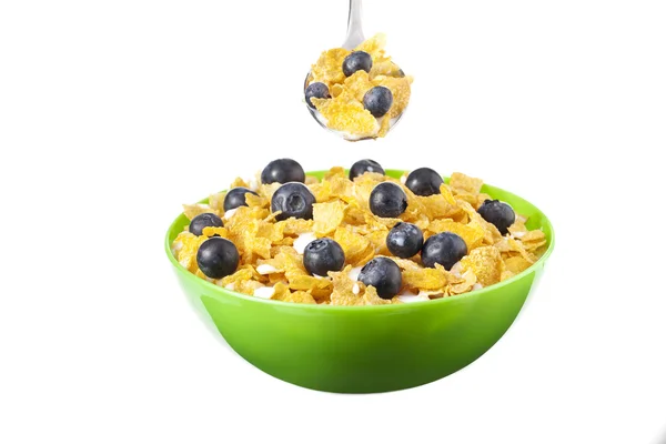 Bowl and spoon of cereals with berry — Stock Photo, Image