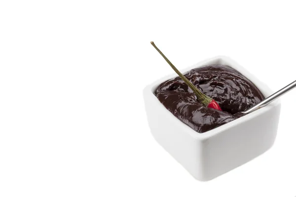 Chili dipped into melted chocolate bowl — Stock Photo, Image