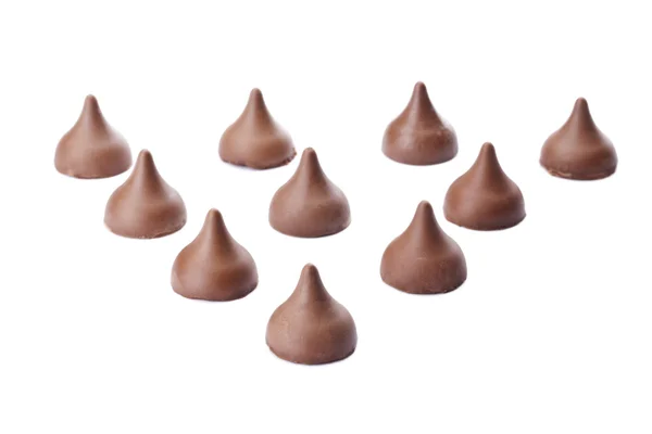 Chocolate chips arranged in triangle — Stock Photo, Image