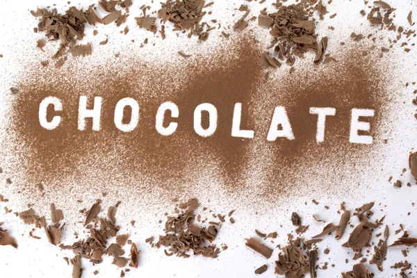 Čokoládový prášek tvořící slovo — Stock fotografie