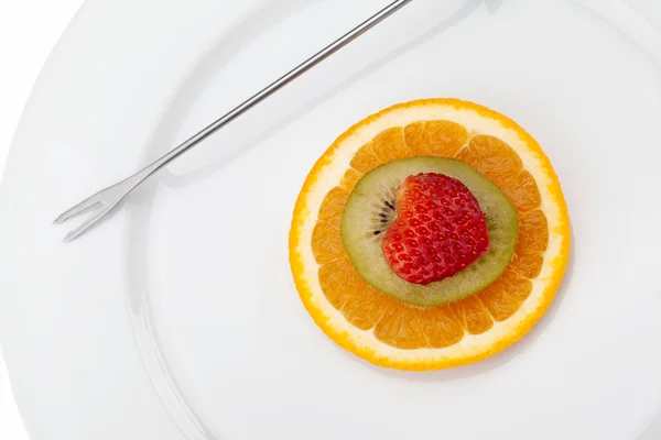 Orange kiwi and strawberry on the plate — Stock Photo, Image