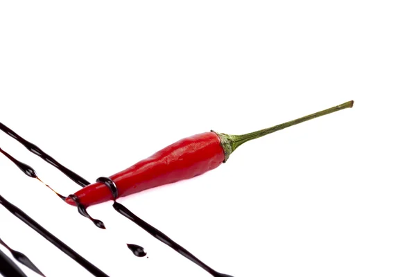 Red chili with chocolate drip — Stock Photo, Image