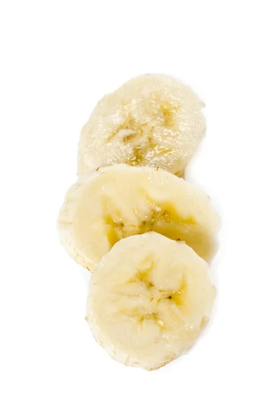 Banana a fette disposta su fondo bianco — Foto Stock