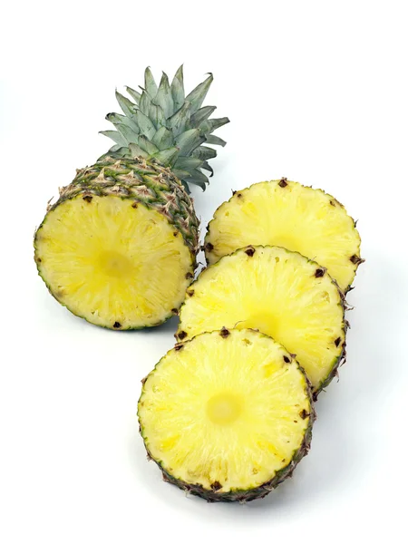 Pineapple top and slices on white — Stock Photo, Image