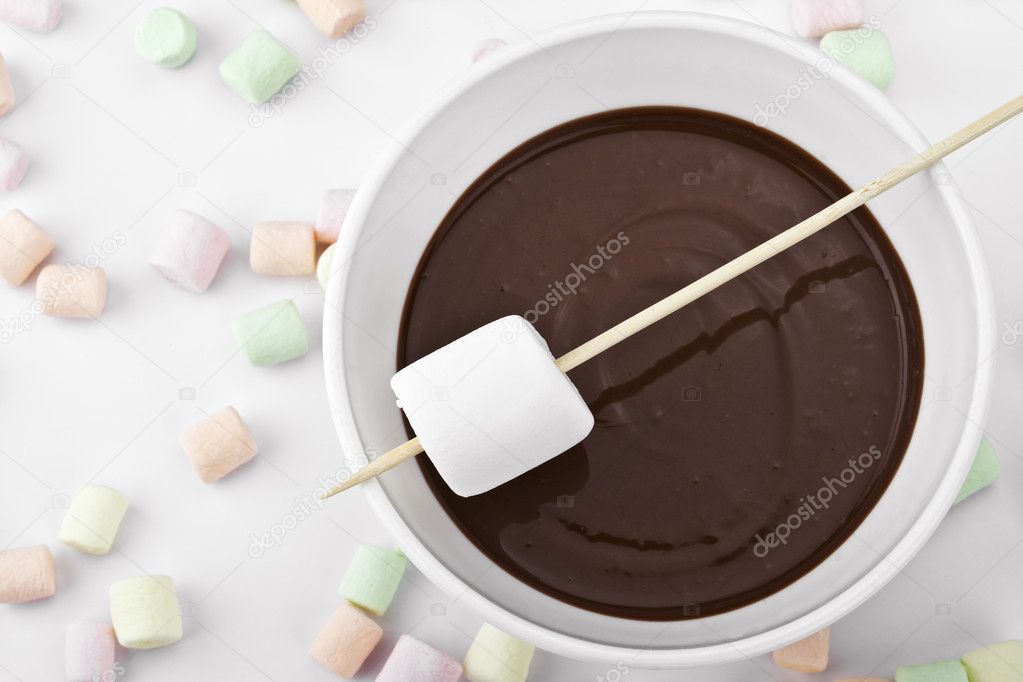 Closed up marshmallow in a stick and melted chocolate