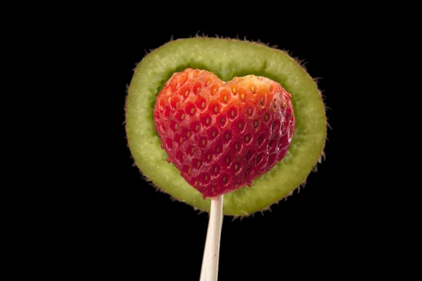 Designed kiwi shelf and strawberry on stick — Stock Photo, Image