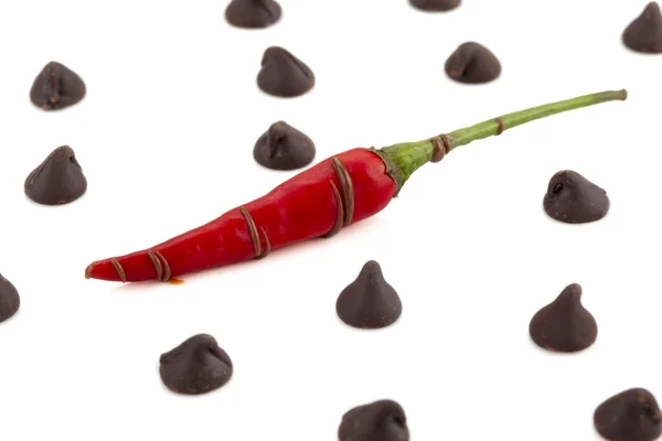 Chilly pepper with chocolate kisses — Stock Photo, Image
