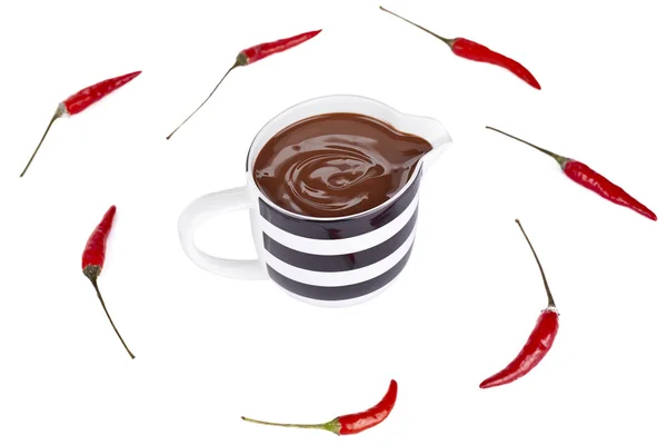 Close up melted chocolate cup and chili — Stock Photo, Image