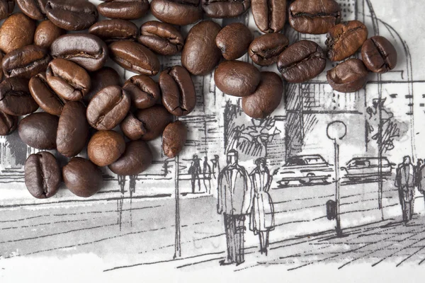 Kaffeebohnen über einer Zeichnung — Stockfoto