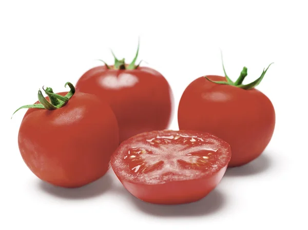 Three tomatoes and a half — Stock Photo, Image