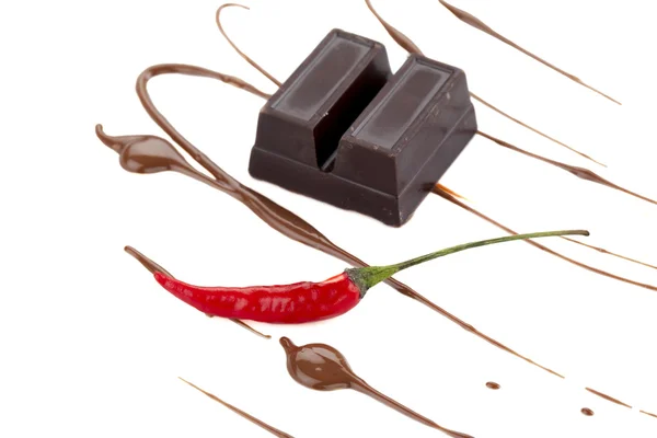 Two sliced chocolate bar with syrup and chili — ストック写真