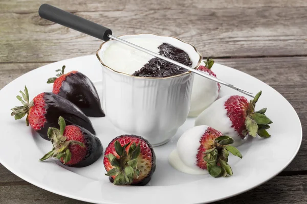Weiße und dunkle Schokolade in Tasse mit Erdbeeren — Stockfoto