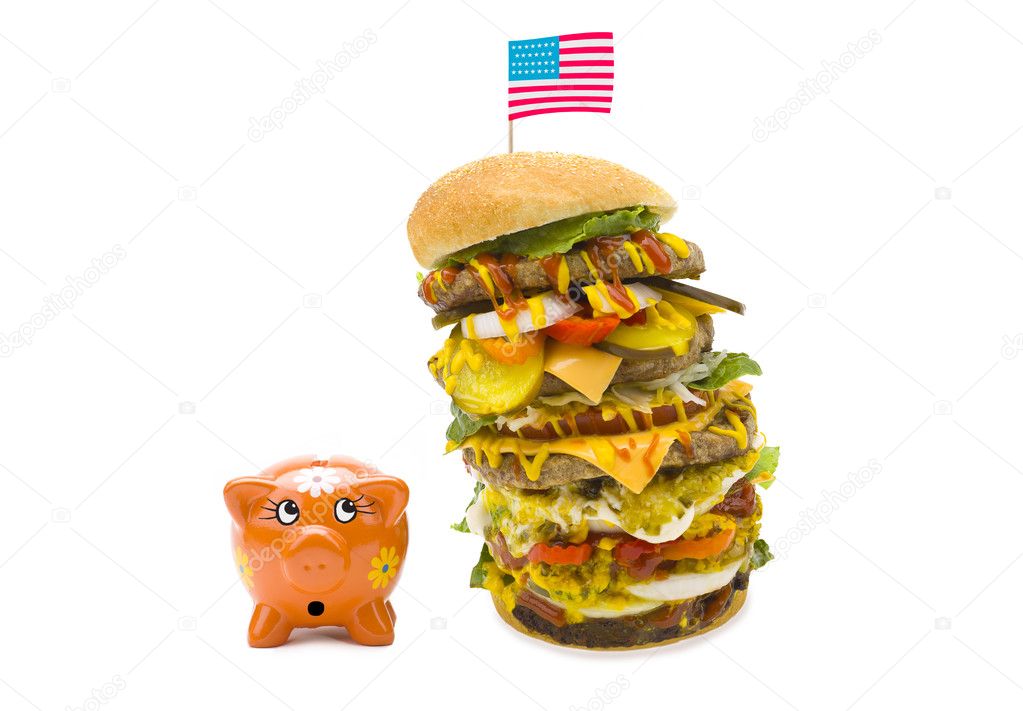 Enormous burger falling over on piggy bank