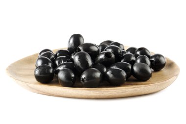 Black olives on wooden plate