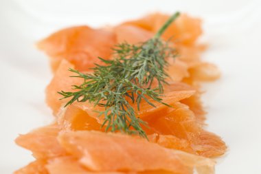 Slices of smoked salmon with dill clipart