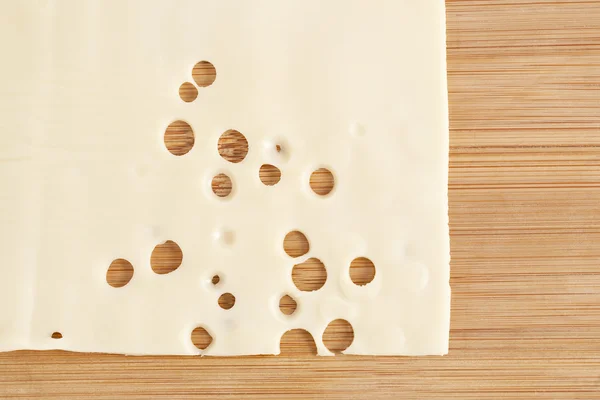 A piece of slice cheese on the table — Stock Photo, Image