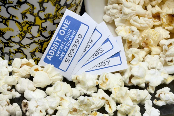 Spilled popcorn with movie tickets