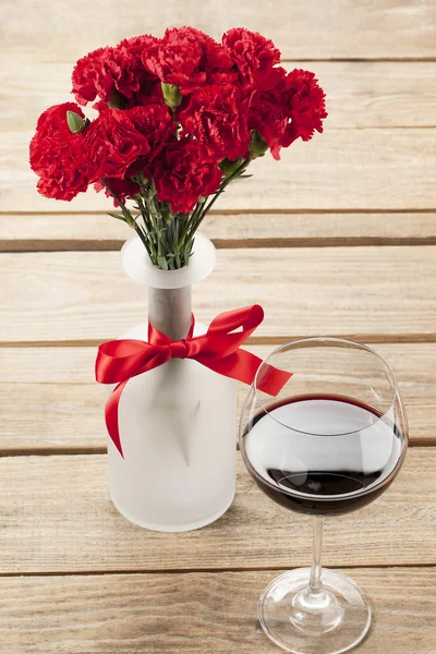 stock image Red flower and wine decorated on table