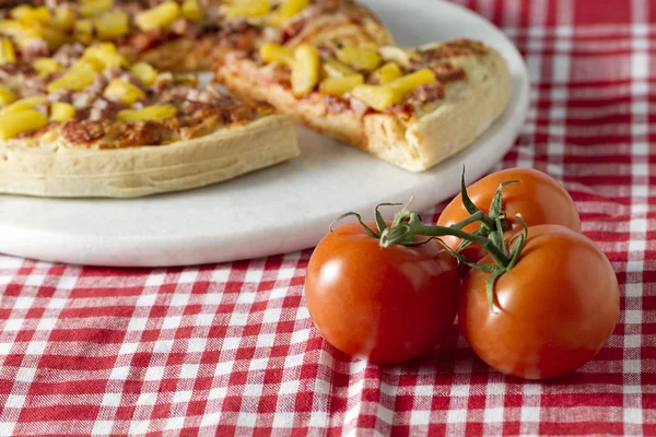 Pizza hawajska i całego dojrzałego pomidora — Zdjęcie stockowe