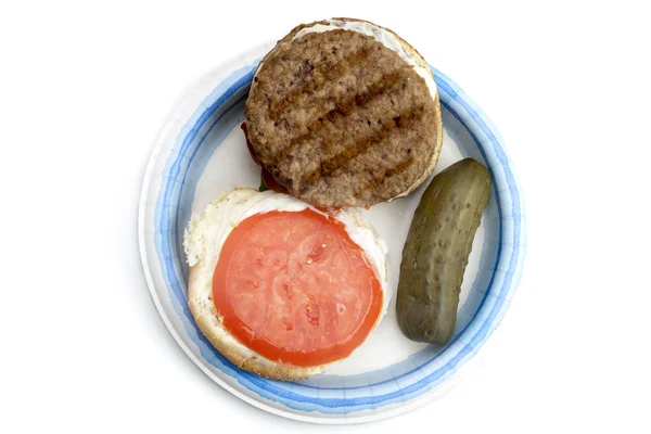Open burger with pickles on a plate — Stock Photo, Image