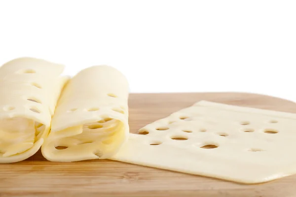 Fatias de queijo em chapa de madeira — Fotografia de Stock