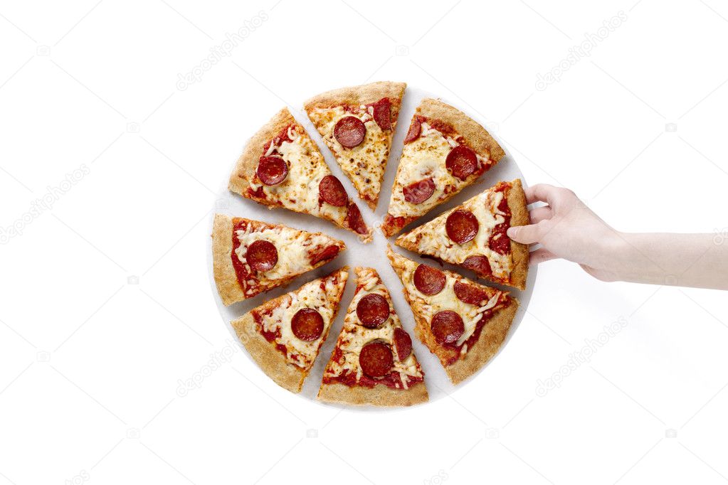 Hand lifting a slice of pepperoni pizza