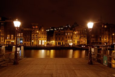 Romantic street view in Amsterdam the Netherlands at night clipart