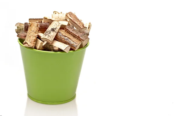 Green bucket full of fire wood blocks — Stock Photo, Image