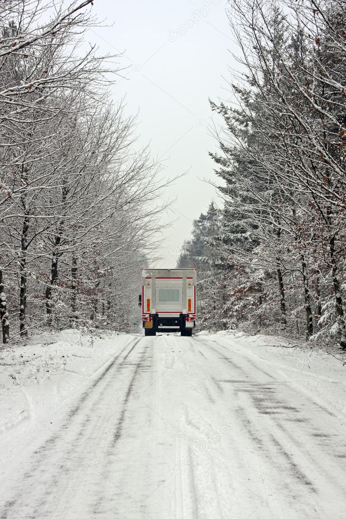 Truck driving in the snow in the countryside from the Netherland