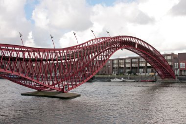 Pedestrian bridge in Amsterdam innercity in the Netherlands clipart