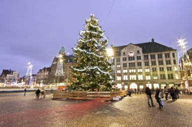 Christmas Tree on Dam Palace in Amsterdam the Netherlands at twilight clipart