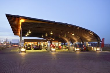 Gas station at twilight clipart