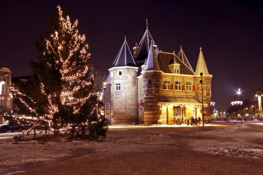 Christmas Tree on Dam Palace in Amsterdam the Netherlands at twilight clipart