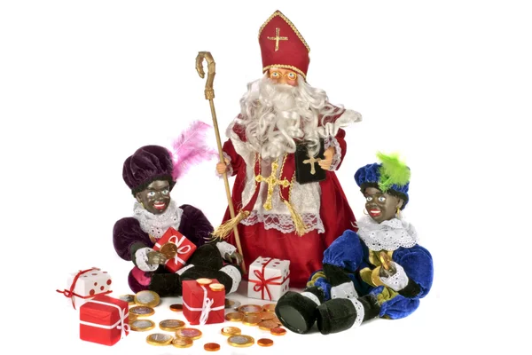 Traditional dutch culture: Santa Claus with his two black pieten with gingernuts and sweets at the 5th of december — Stock Photo, Image