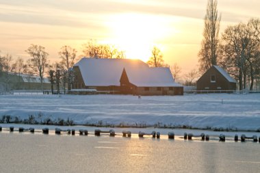 Snowy house in a Dutch Winter landscape clipart