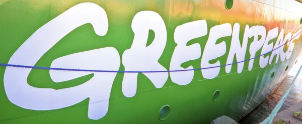 Greenpeace sign on green — Stock Photo, Image