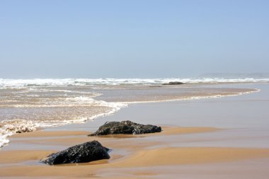 Rock in the ocean near Lagos in Portugal clipart