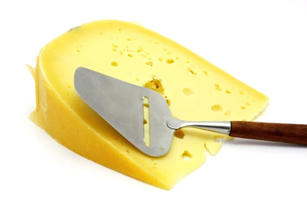 Piece of real dutch cheese with holes and dutch cheese cutter isolated on white — Stock Photo, Image