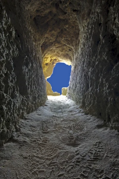 stock image Going to the light: tunnel in a rock towards the blue sky in Portugal