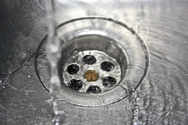 Wasser aus dem Wasserhahn in die Spüle — Stockfoto