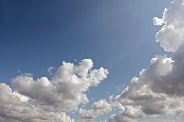 Όμορφη cloudshape με τις ακτίνες του ήλιου και το γαλάζιο του ουρανού — Φωτογραφία Αρχείου
