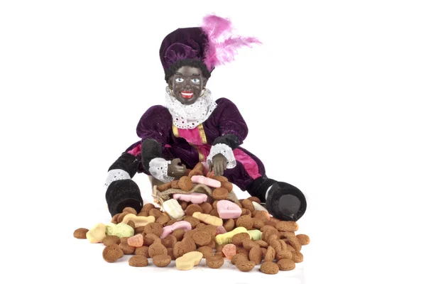 Fekete Piet ül egy gingernuts és cukorka táska — Stock Fotó