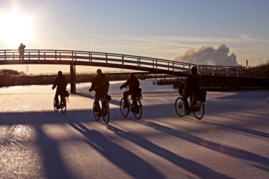 Cyclists on ice clipart